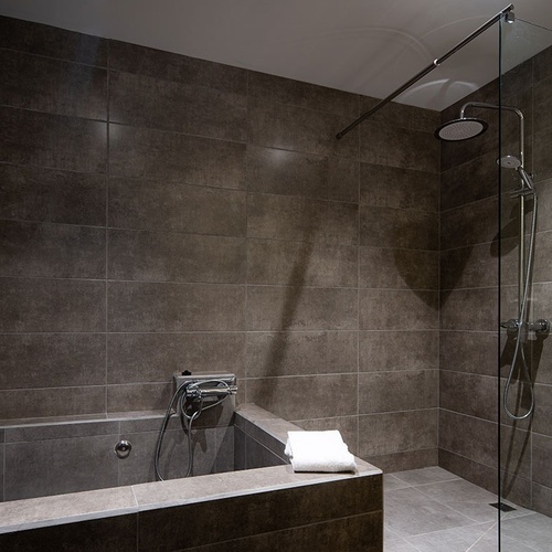 a bathroom with a walk in shower and a bathtub