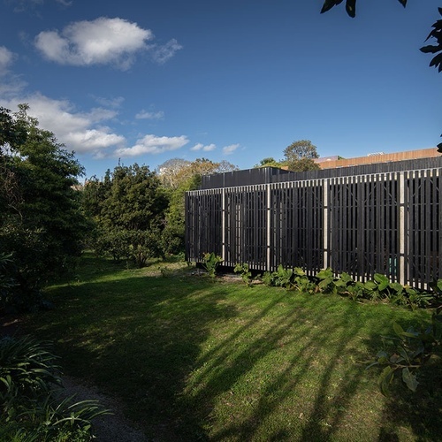 a black fence surrounds a lush green yard