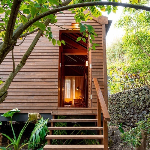 a wooden house with stairs leading up to it