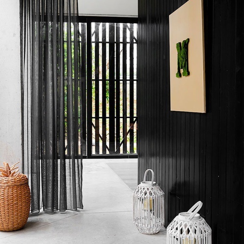 a black wall with the letter m on it