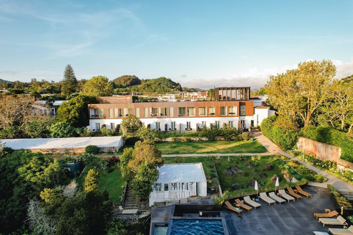 uma grande casa branca com uma grande piscina em frente a ela