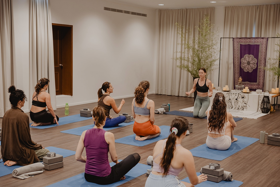 Yoga class in a bright, modern hotel studio. Senhora da Rosa for wellness.