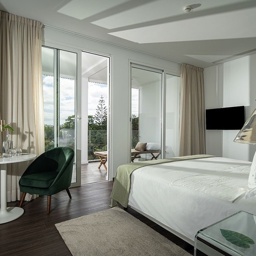 a hotel room with a bed a chair and a table