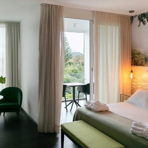 a hotel room with a large bed and a balcony