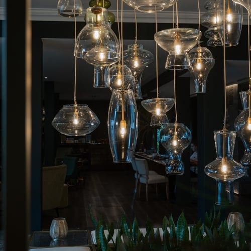 a room with a lot of lights hanging from the ceiling