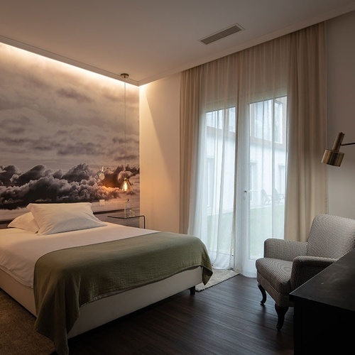 a hotel room with a bed and a chair