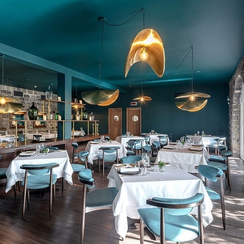 a dining room with tables and chairs and a blue ceiling
