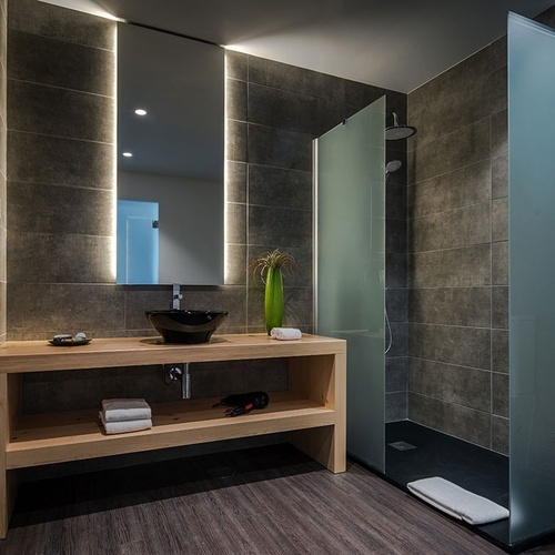 a bathroom with a sink and a walk in shower