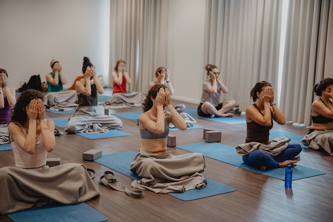 Yoga class in a tranquil hotel studio, promoting wellness and Senhora da Rosa.