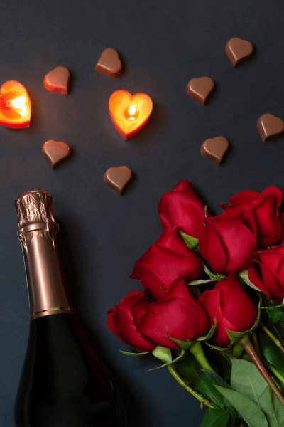 a glass filled with red and purple chocolate hearts