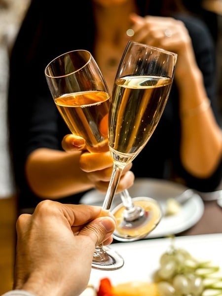 a man and a woman are toasting with champagne glasses