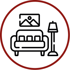 an icon of a living room with a couch , lamp and picture on the wall .