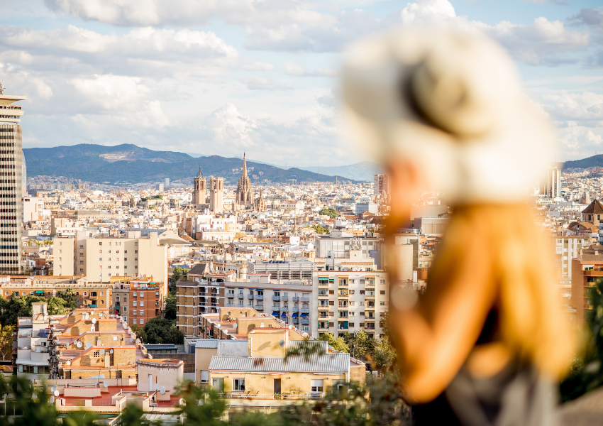 a woman wearing a hat is walking down a dirt road