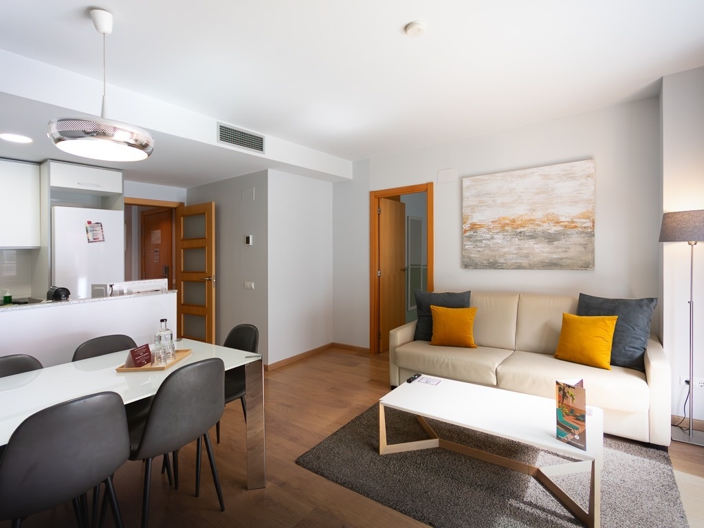 a living room with a white couch and a flat screen tv