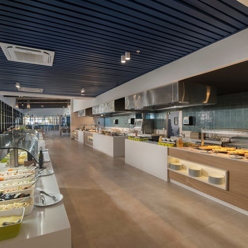 a buffet line in a restaurant with a pizza oven