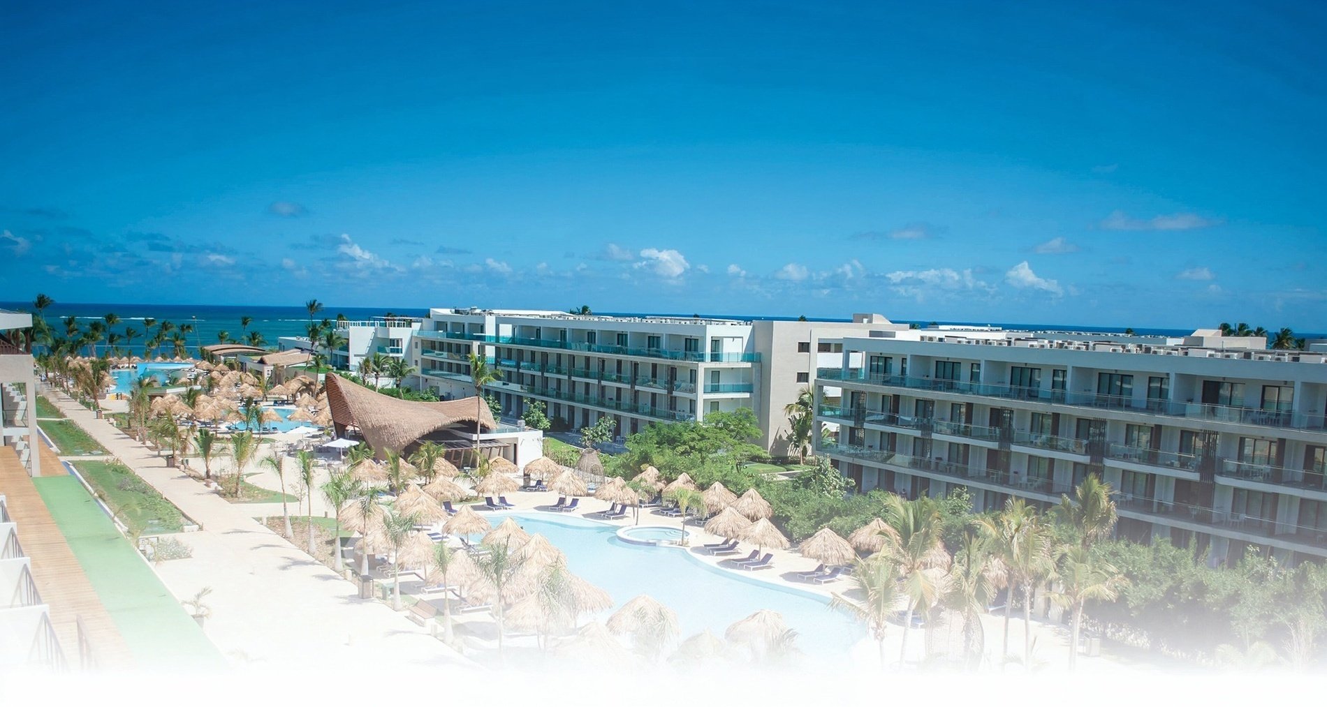 an aerial view of a resort with a large pool
