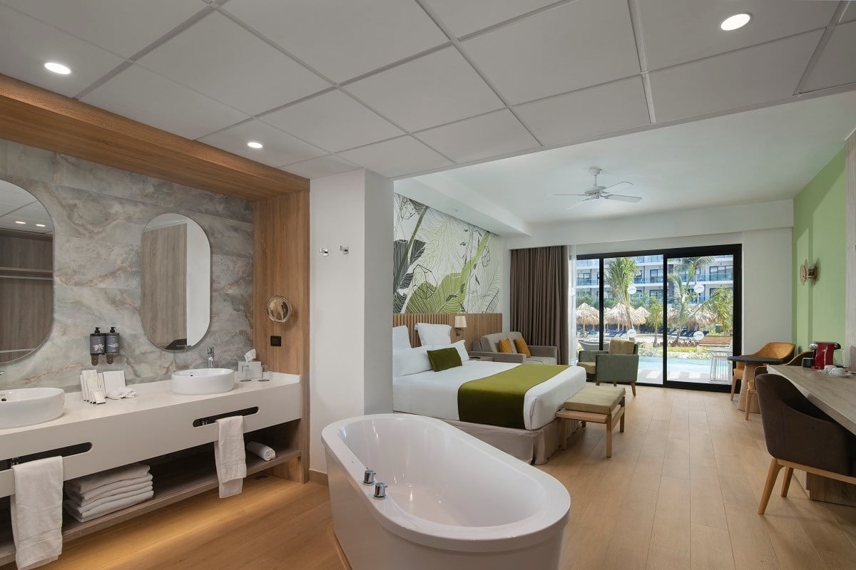 a hotel room with a king size bed and a bathtub