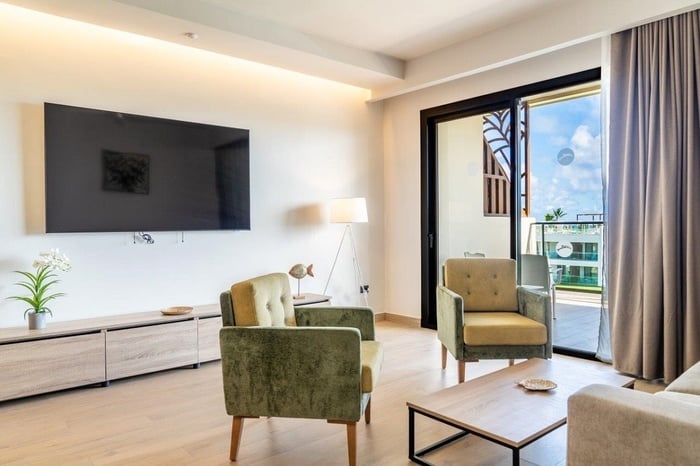 a living room with two chairs and a flat screen tv