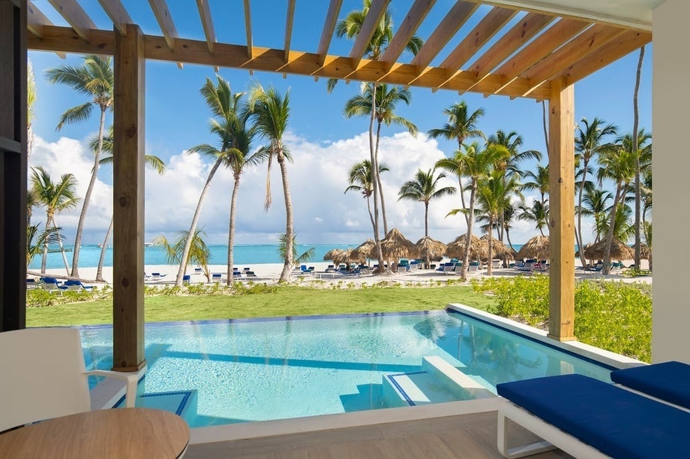 a view of a swimming pool with palm trees in the background