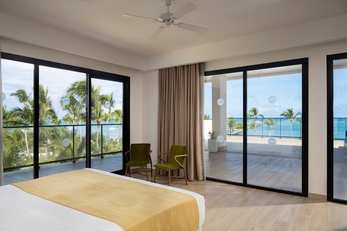 a swimming pool with a view of the ocean and palm trees