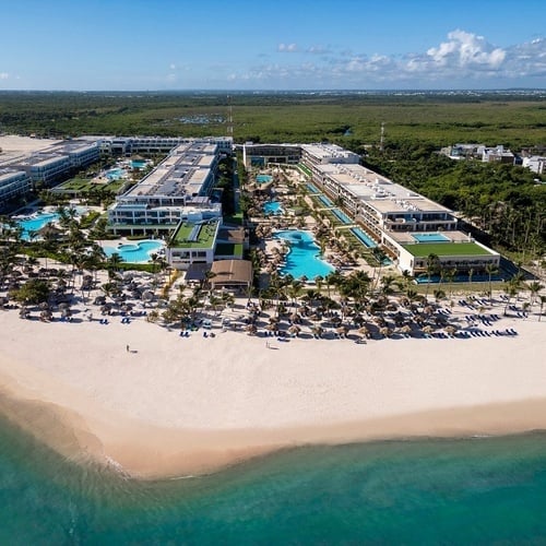 an aerial view of a large resort with a beach in the foreground