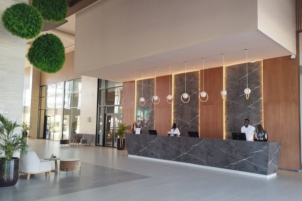 a hotel lobby with two people behind a counter
