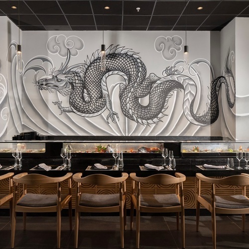 a restaurant with a mural of a dragon on the wall