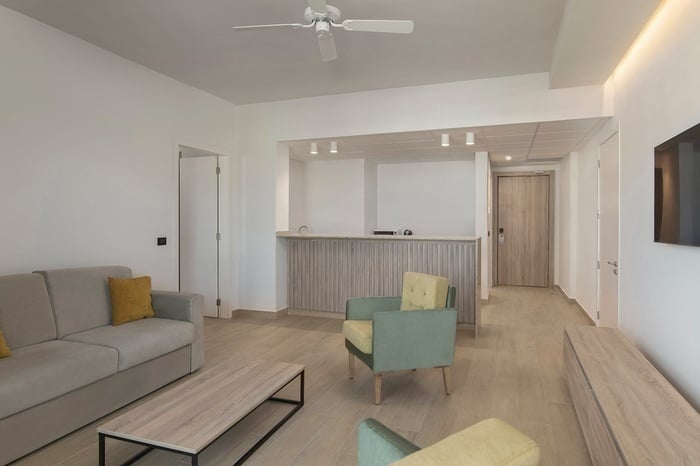 a living room with two chairs and a flat screen tv