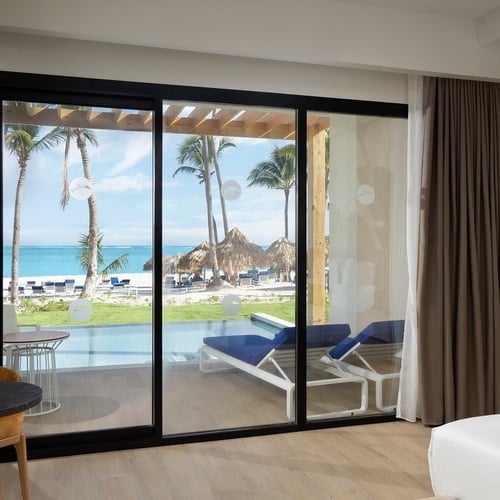 a hotel room with a large bed and a ceiling fan