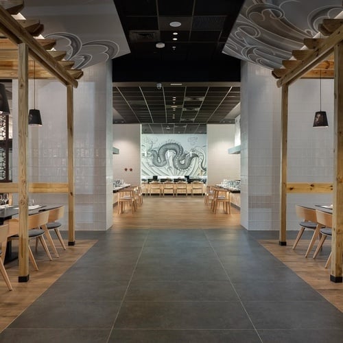 a dining room with a mural of a fish on the wall