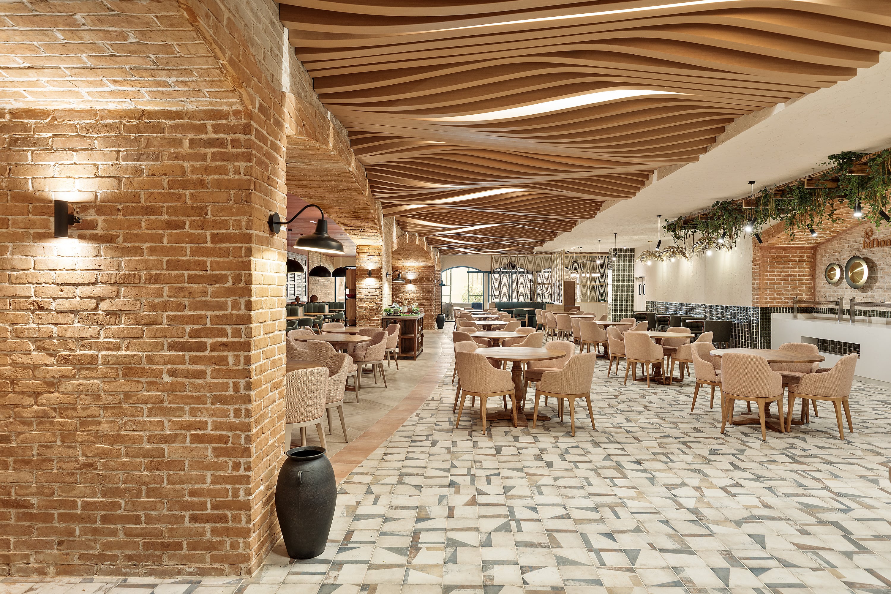 Serenade Caribe Club's elegant lounge with wine cellar, rustic wooden tables, and chairs.