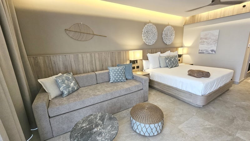 Double room at Serenade Caribe Club with comfortable beds and modern decor.