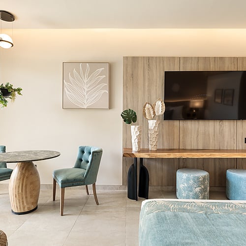 Luxury Serenade Caribe Club room with king bed and sofa seating