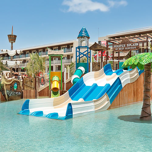 Pirates Splash water park at Serenade Caribe Club resort, featuring slides and a pirate ship structure.