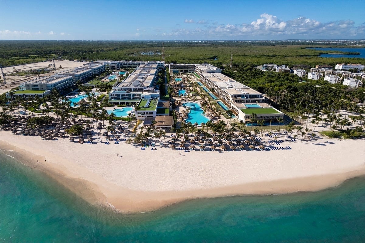 an aerial view of a large resort with a beach in the foreground