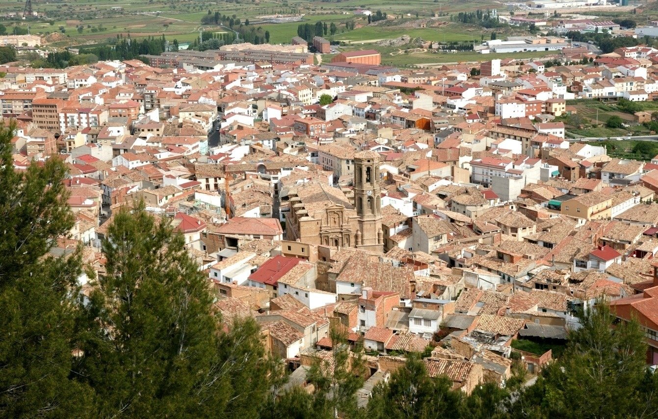 an aerial view of a city with a church in the middle