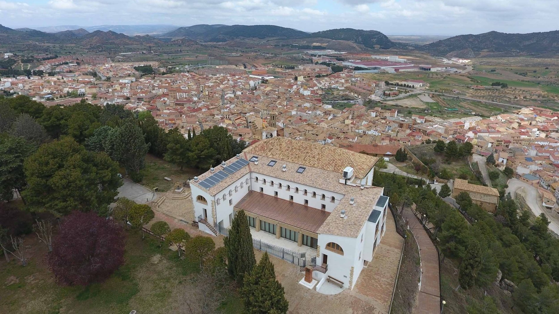 an aerial view of a city with a church in the middle