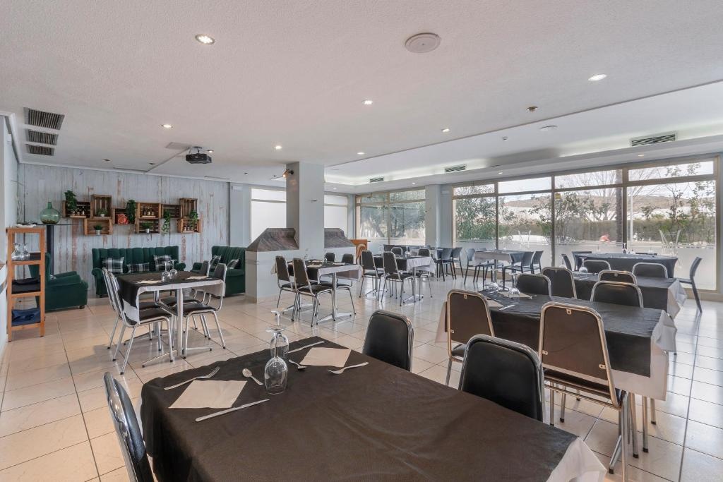 Birmajus: Sierra de Arcos dining hall, set for evening meals with dressed tables and chairs.