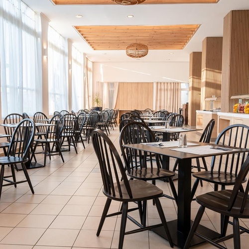 a restaurant with tables and chairs and a buffet