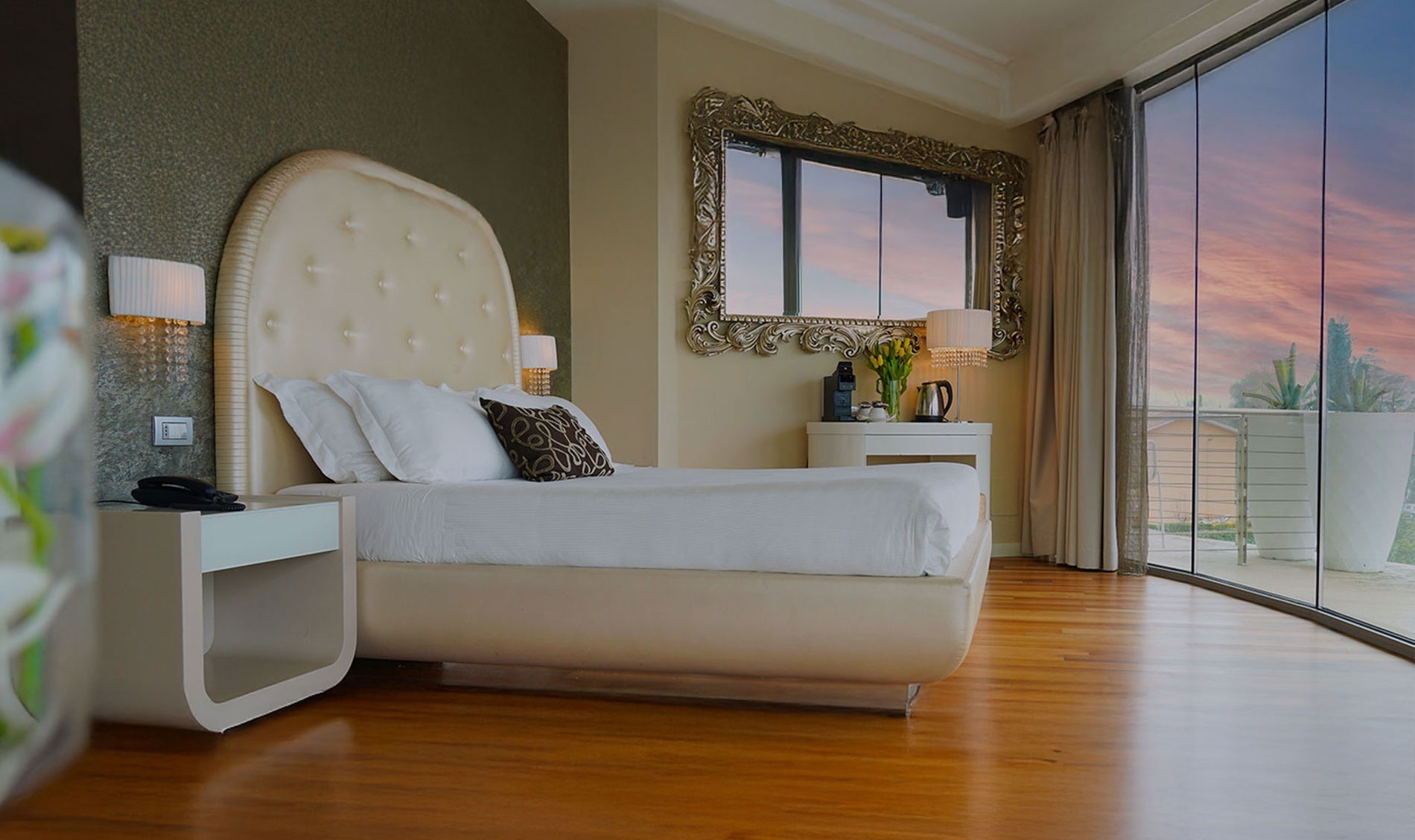 a patio with tables and chairs surrounded by potted plants
