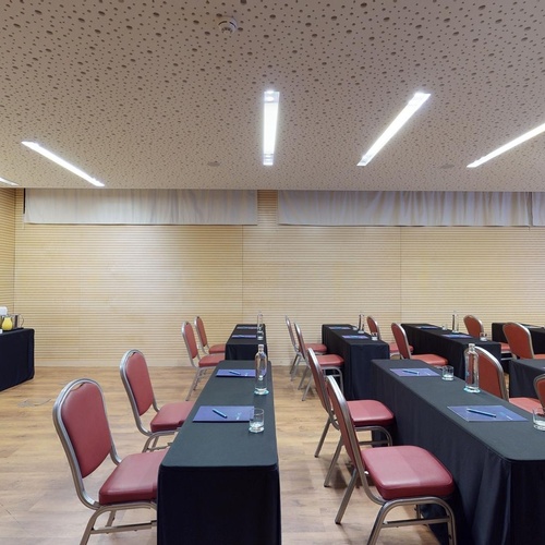 a conference room with tables and chairs and a projector