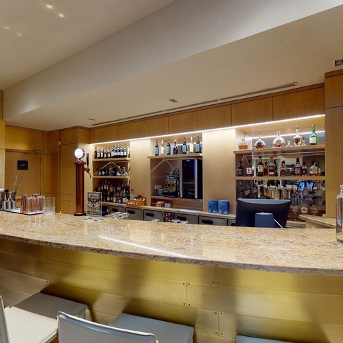 a bottle of aquafina water sits on the counter of a bar
