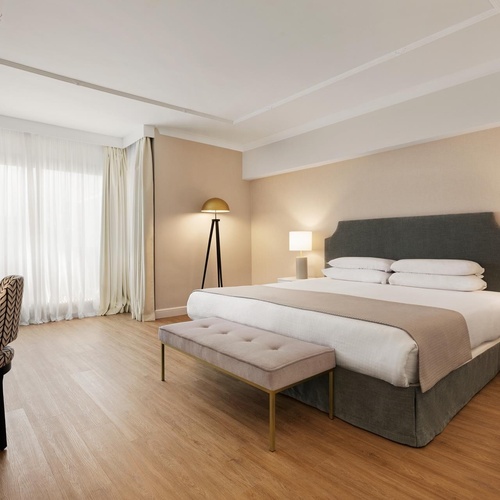 a hotel room with a large bed and a desk