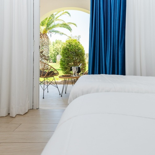 a hotel room with two beds and a blue curtain