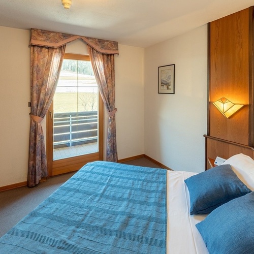 a bedroom with a bed and a picture on the wall