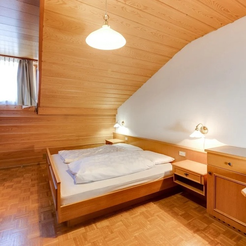 a bedroom with a picture on the wall above the bed