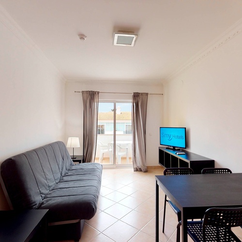 a living room with a couch a table and a flat screen tv