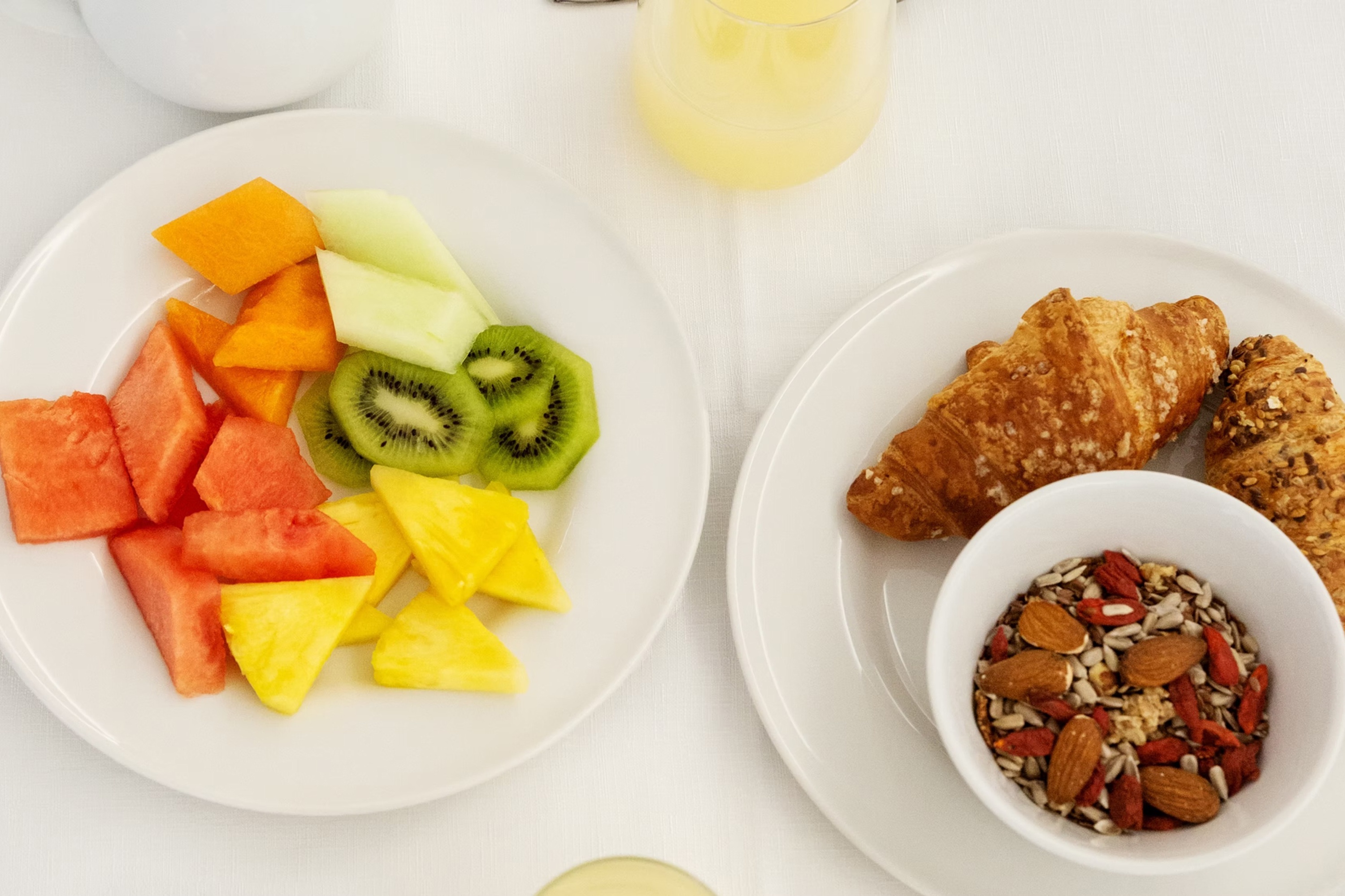 a glass of red liquid with a straw on the beach