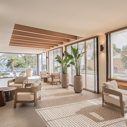 Stylish Smy: Corporativa hotel lobby with central olive tree and circular seating.
