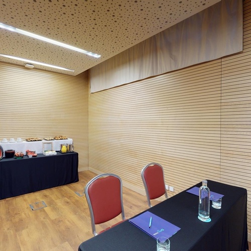 a conference room with a table and chairs and a buffet